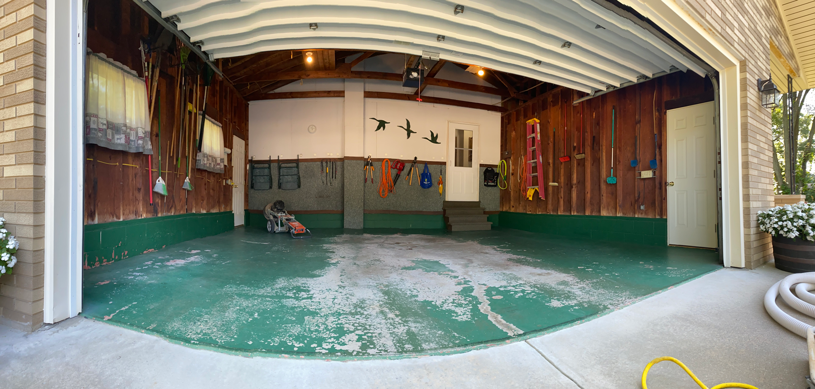 Worn garage floor showing signs of damage